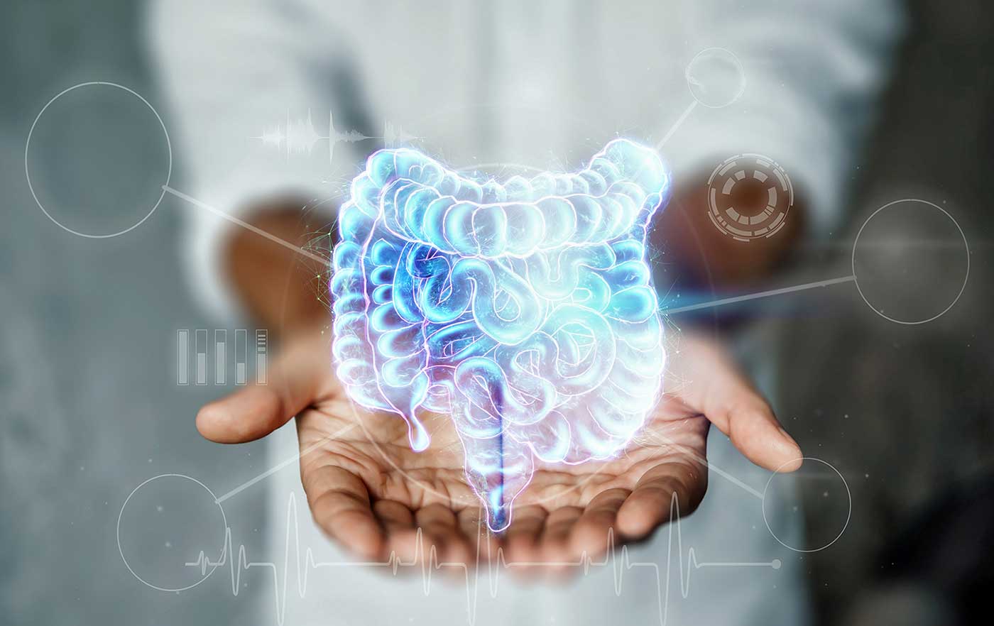 Doctor and holographic bowel scan projection with vital signs and medical records, showing the concept of new technologies and paths to better health.